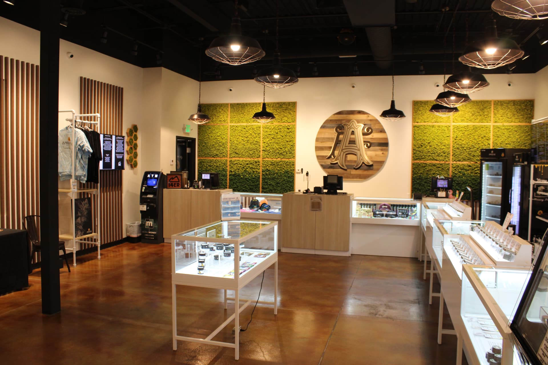 Apothecary Farms Pueblo West sales floor with moss walls, display cases and merch