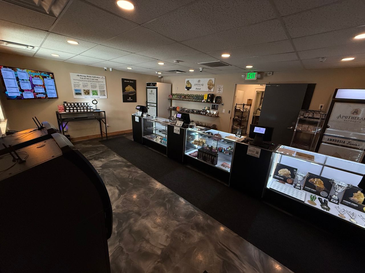 Apothecary Farms Federal sales floor with display cases, awards and digital menus