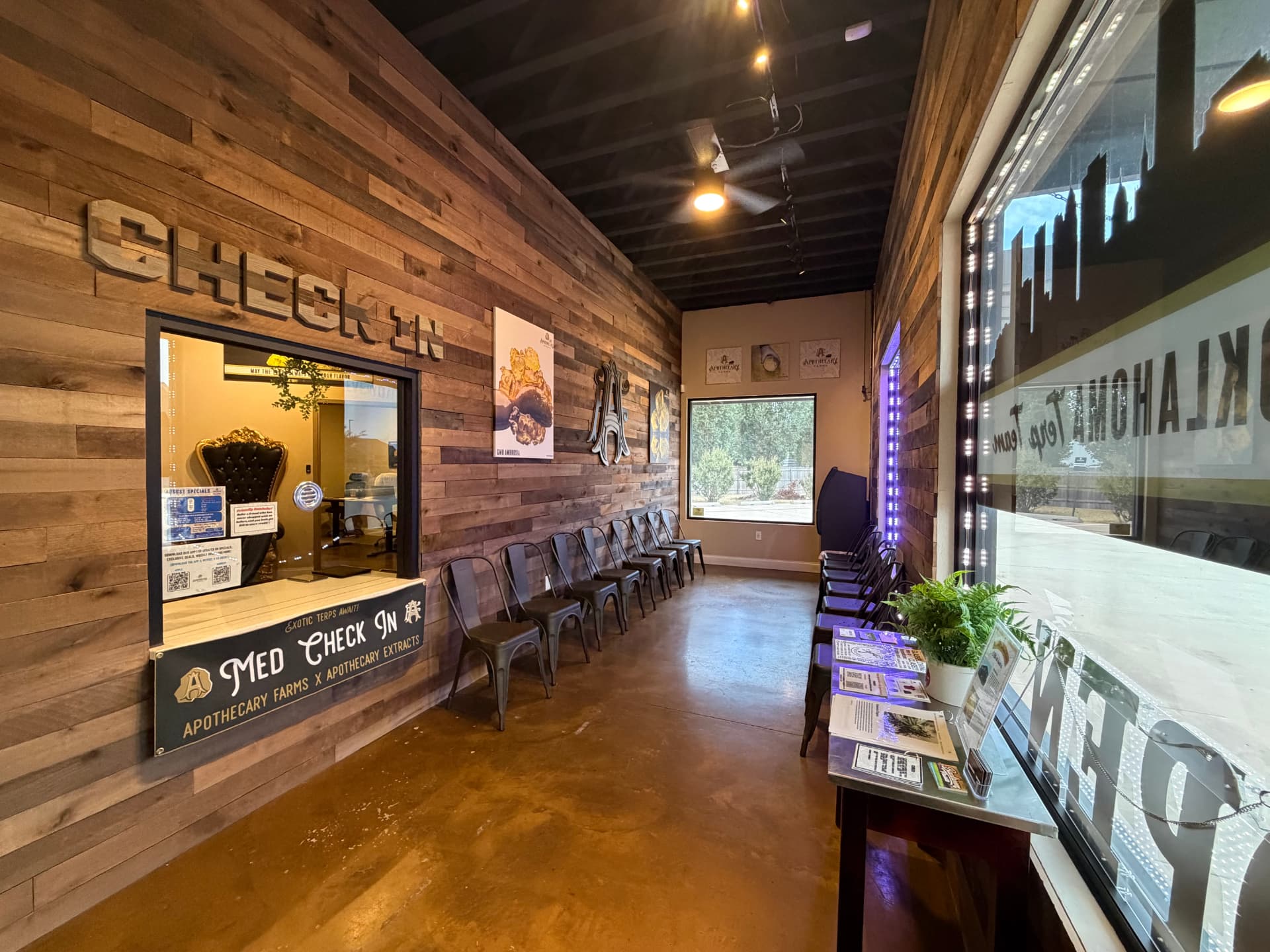 Apothecary Farms North May lobby with reclaimed wood check-in wall and Oklahoma Terp Team graphics