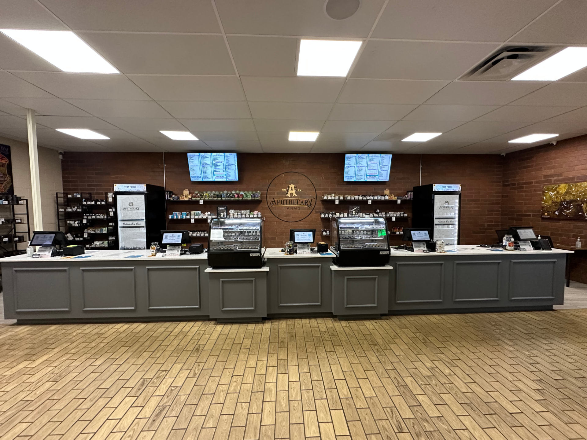 Apothecary Farms Academy sales floor with long counter, terp fridges and digital menus