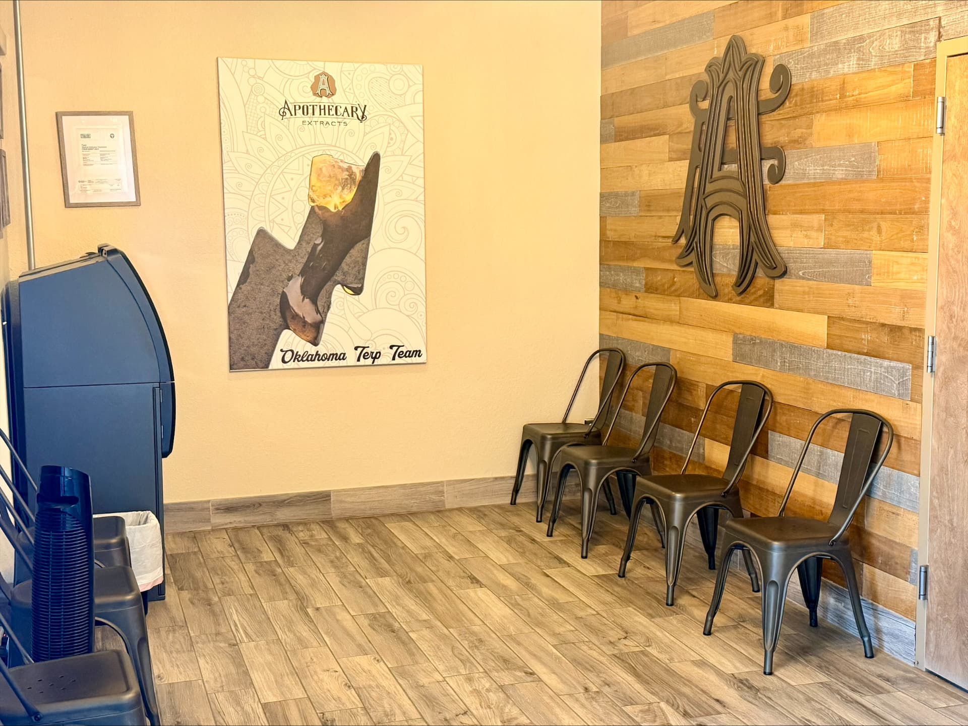 Apothecary Farms Tulsa lobby with Oklahoma Terp Team artwork and reclaimed wood wall
