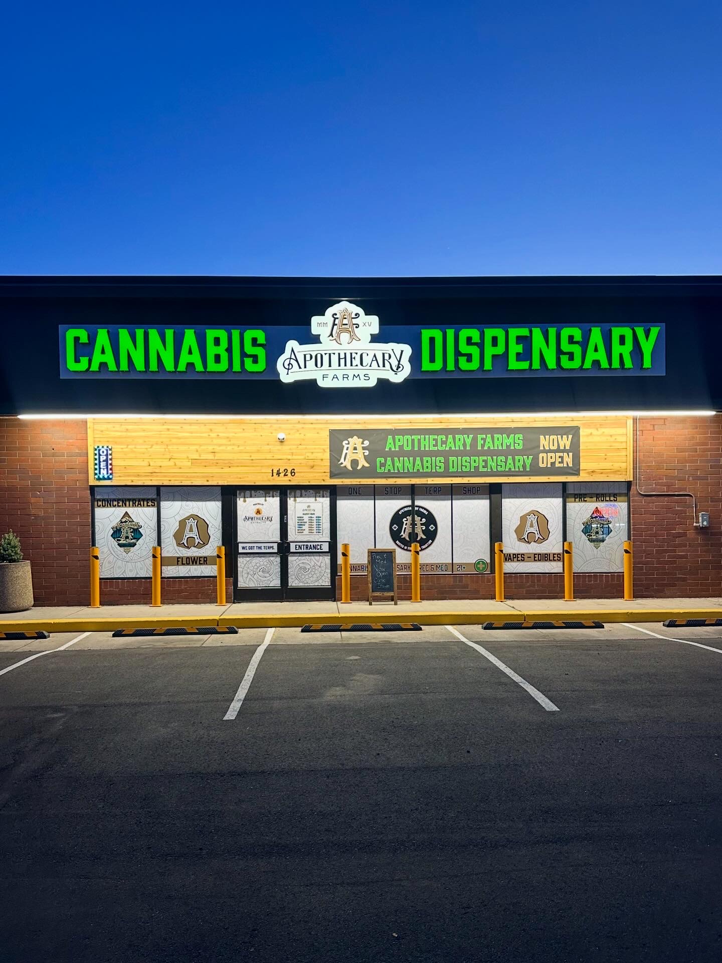 Apothecary Farms Academy cannabis dispensary storefront lit up at dusk in Colorado Springs