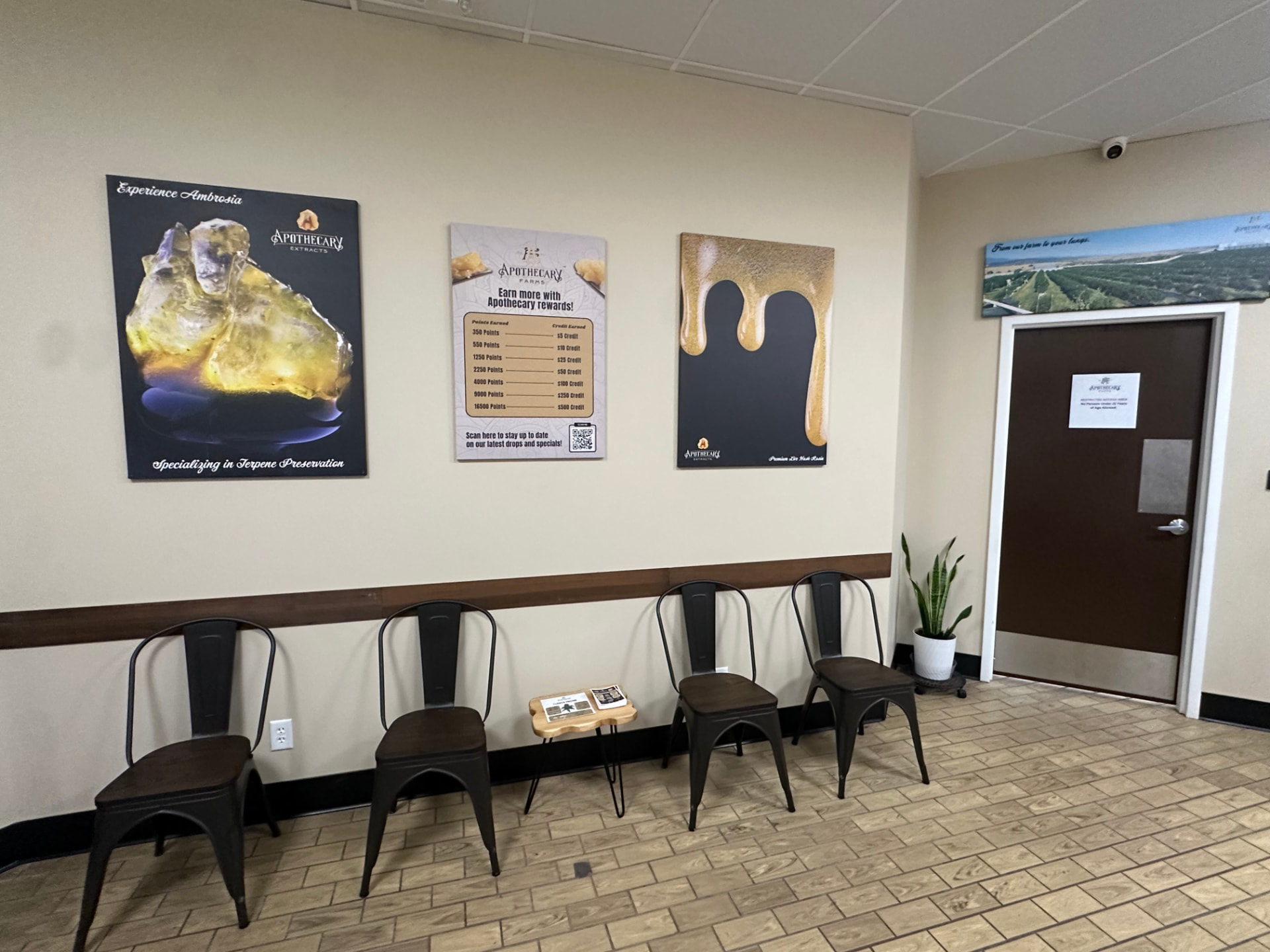 Apothecary Farms Academy lobby with Experience Ambrosia artwork and rewards board