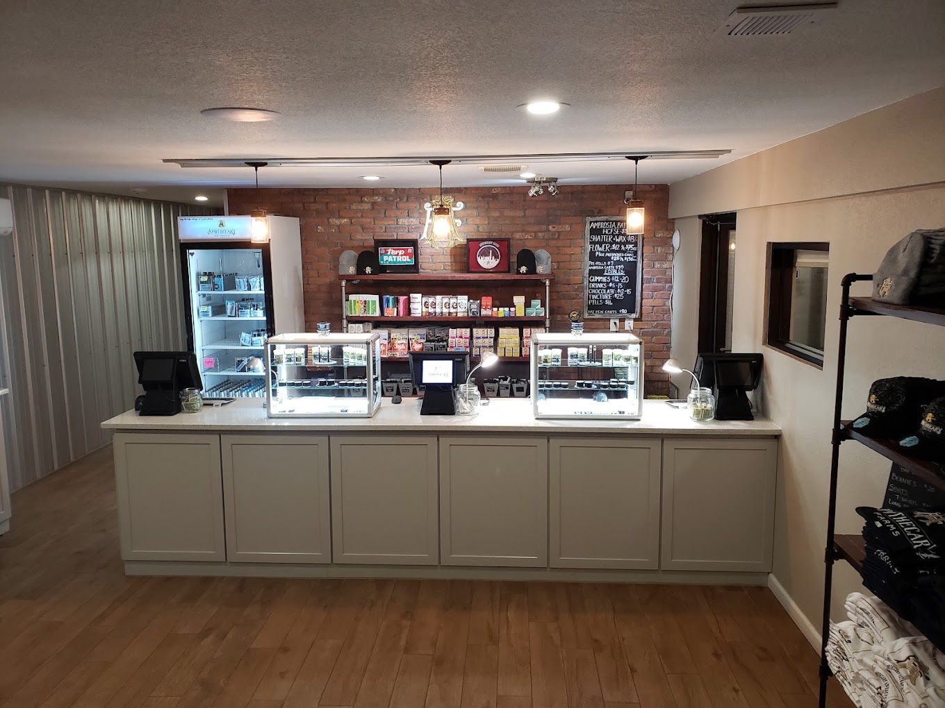 Apothecary Farms Pueblo main counter with concentrate cases, terp fridge and price boards