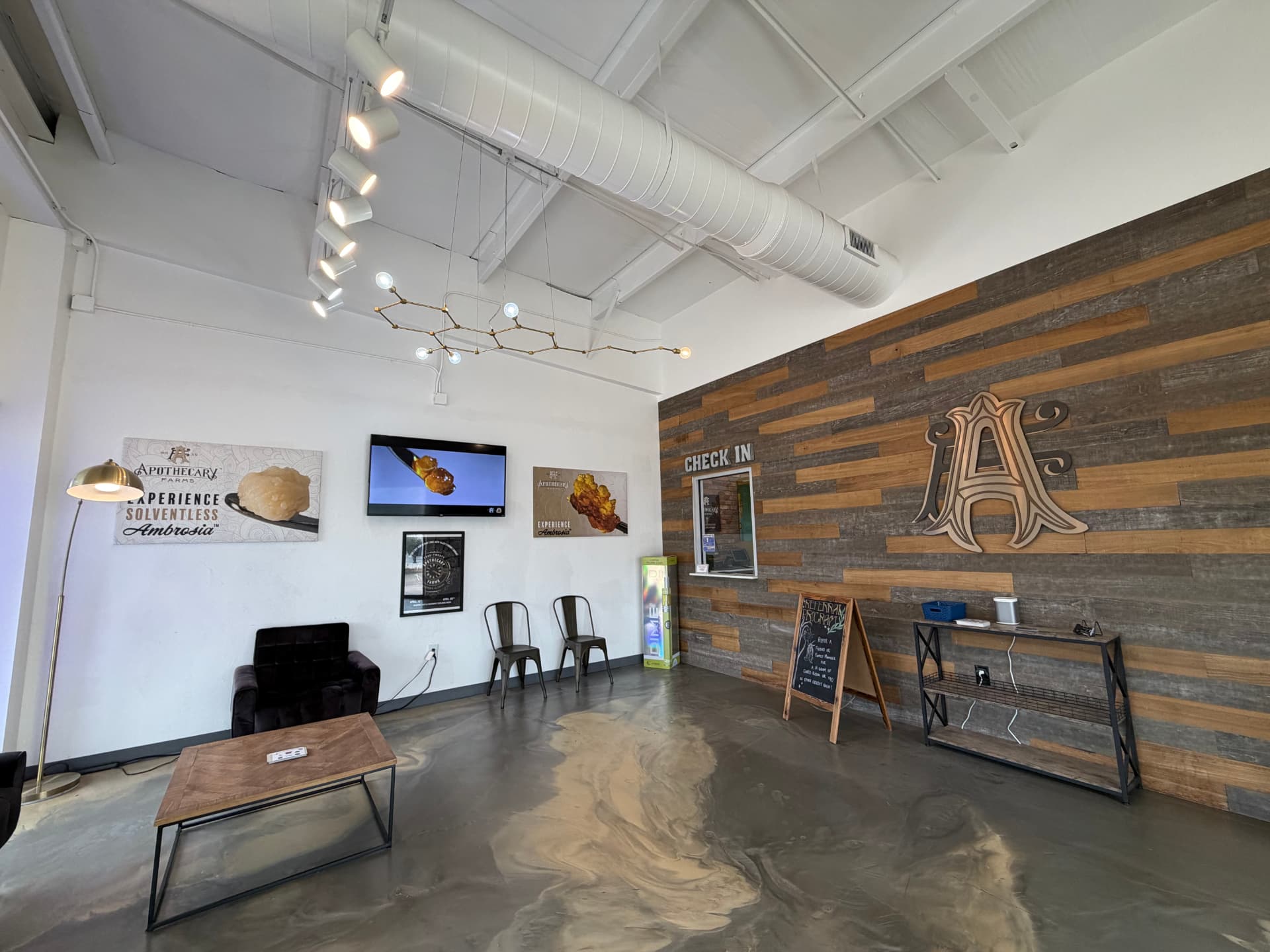 Apothecary Farms Moore lobby with reclaimed wood check-in wall and Ambrosia artwork